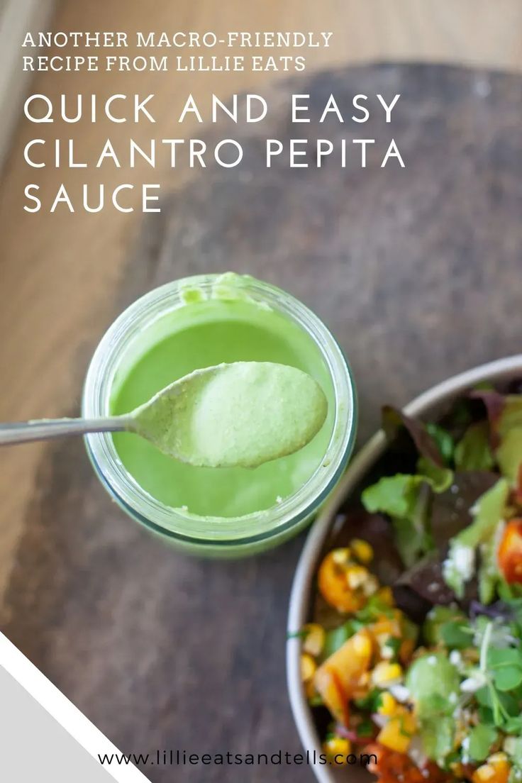 a bowl of food with a spoon in it next to a glass filled with green liquid