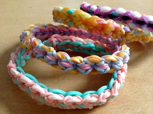 three different colored bracelets sitting on top of a table