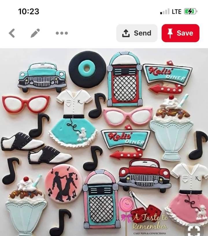 decorated cookies are arranged in the shape of musical instruments and women's clothing on display