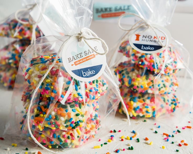 three bags filled with colorful sprinkles on top of a table