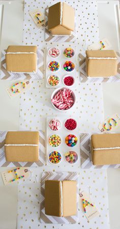 a table topped with lots of boxes filled with candy