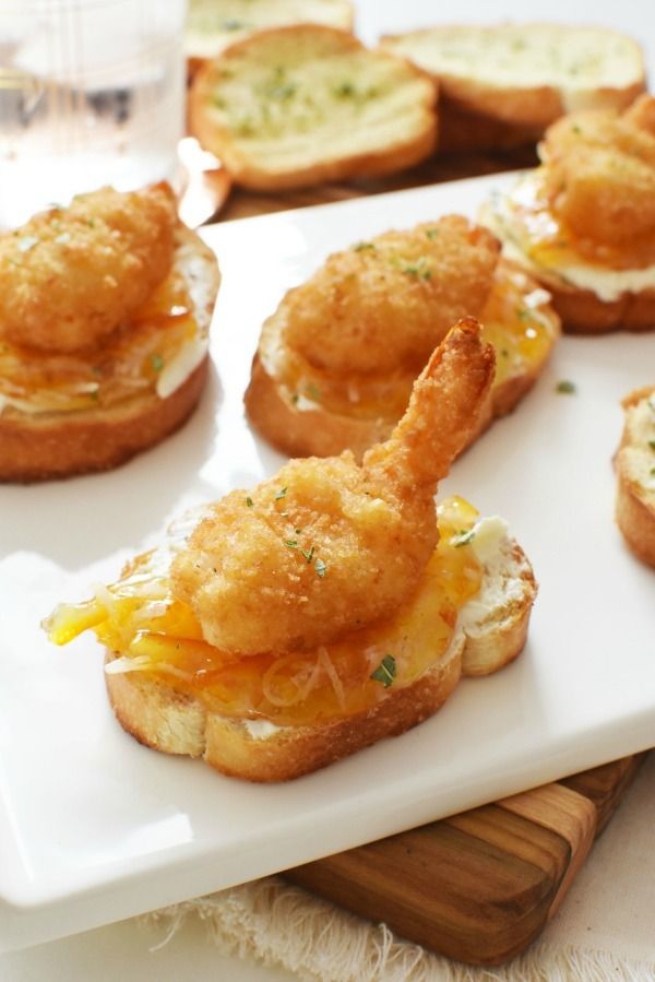 small appetizers are arranged on a white plate, ready to be eaten and served