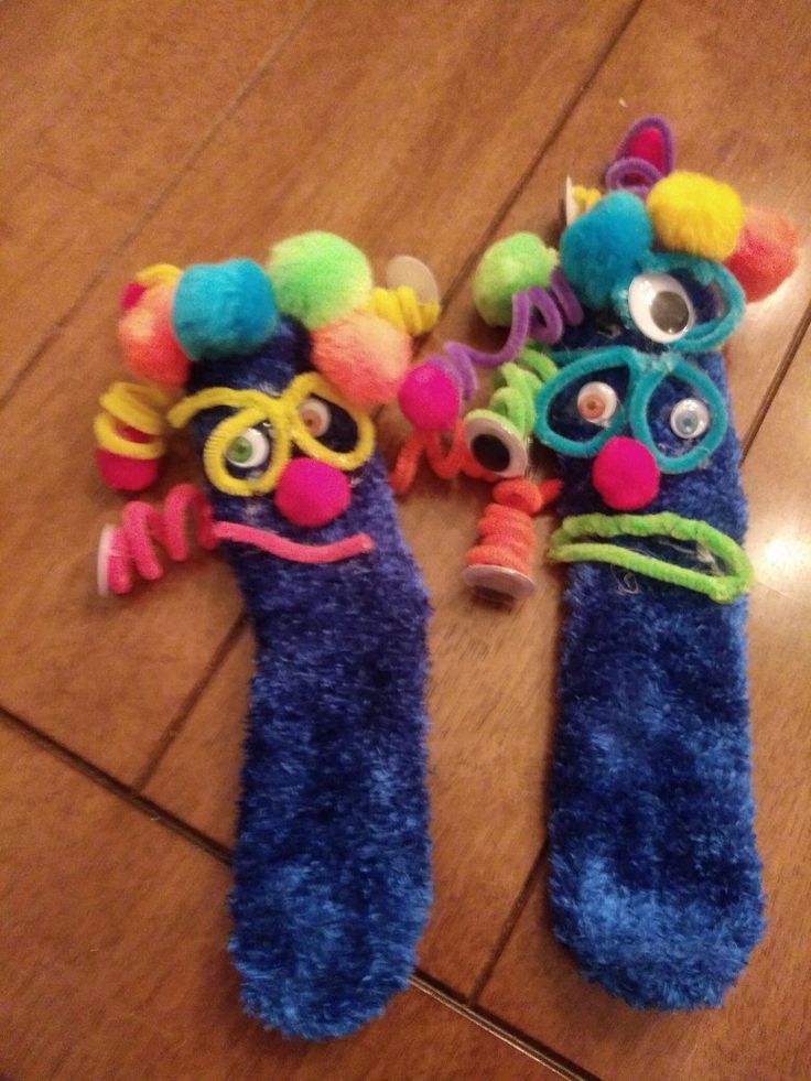 two stuffed animal toys laying on the floor next to each other with eyes and ears