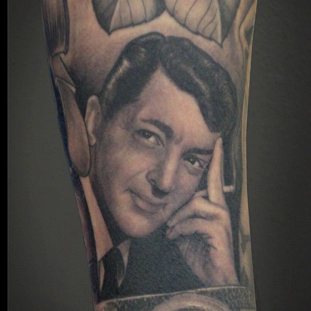 a man's arm with an image of himself on the phone and another portrait