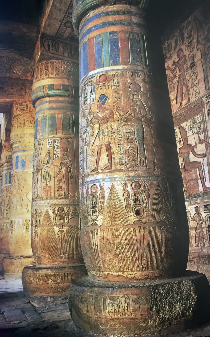 two large columns with egyptian designs on them