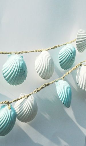 several seashells are hanging on a string