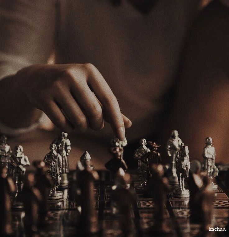 a person is playing chess on a table