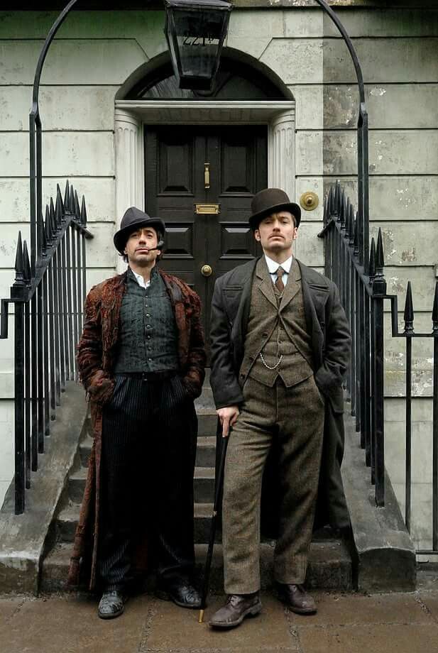 two men standing in front of a building