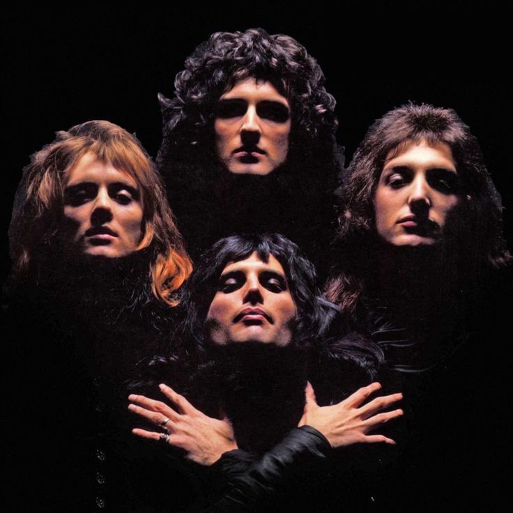 the band queen of rock and roll posing for a photo in front of black background