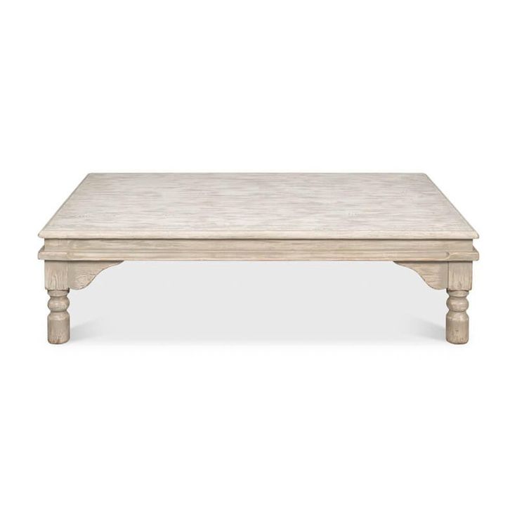 a white coffee table with wooden legs and a marble top on an isolated white background