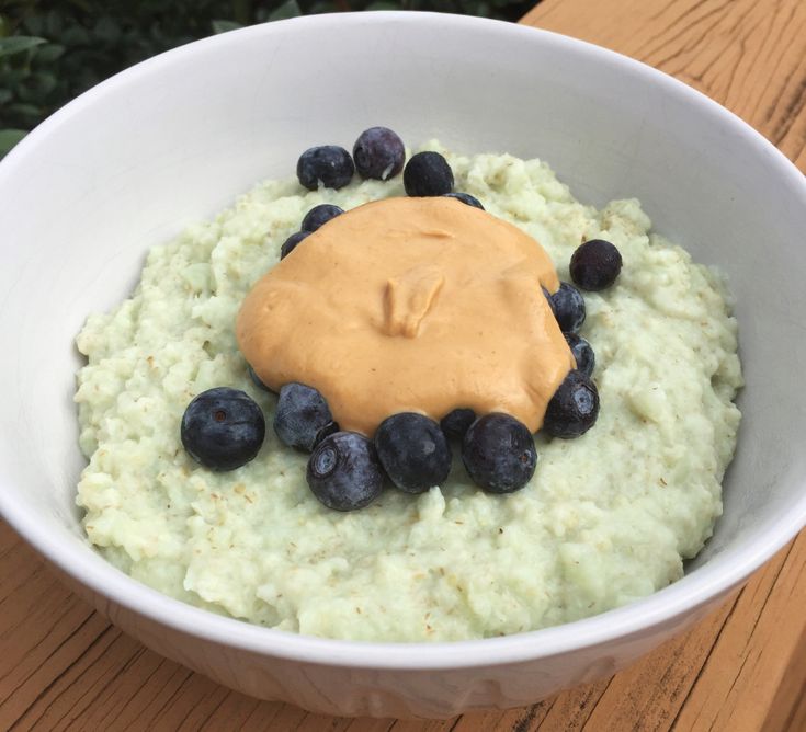 a bowl filled with oatmeal and blueberries