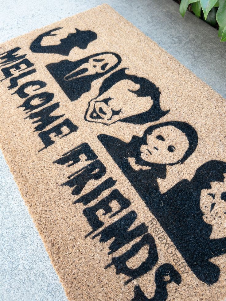 a welcome mat that has the words welcome home and two men on it in black