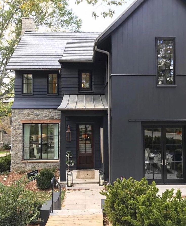 a house that is painted blue with black trim