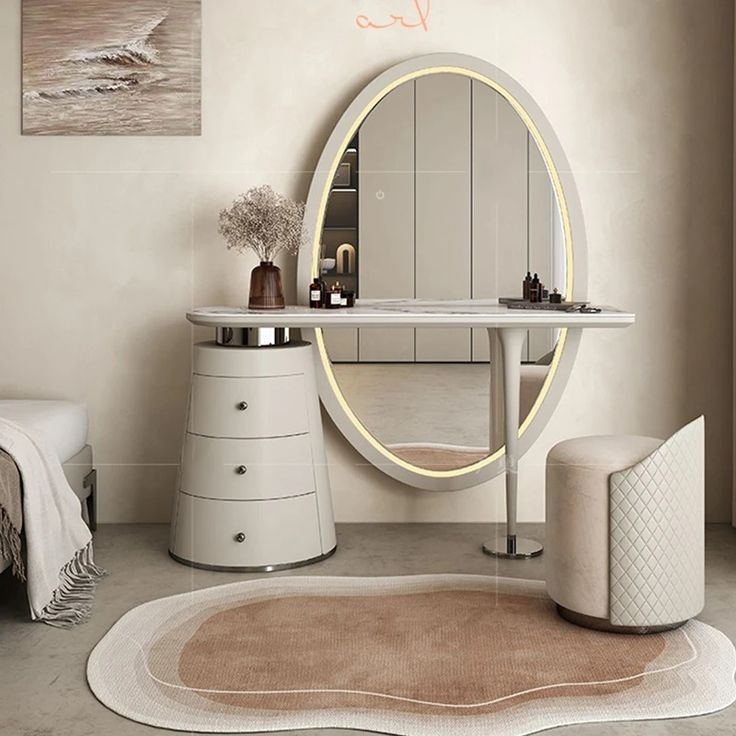 a bathroom with a round mirror on the wall next to a white vanity and stool