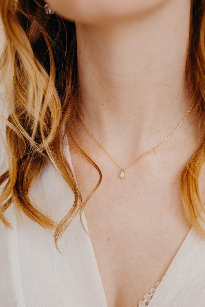 Our Remi Necklace is your new favorite dainty, everyday necklace. This delicate necklace features a tiny cubic zirconia rectangle that is so petite and sparkly! It hangs on a very thin, yet strong 14k gold filled snake chain. #wanderandlustjewelry #daintynecklace #bohostyle #layeringnecklace #giftsforher #goldjewelry Danty Necklace, Tiny Gold Necklace, Simple Gold Necklace, Gold Necklace Dainty, Dainty Diamond Necklace, Gold Necklace Simple, Diamond Solitaire Necklace, Dainty Gold Necklace, Emerald Necklace