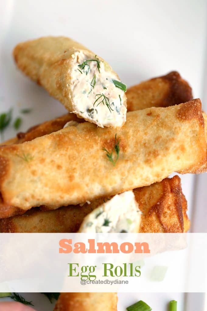 an egg roll on a white plate with green beans and parsley in the middle