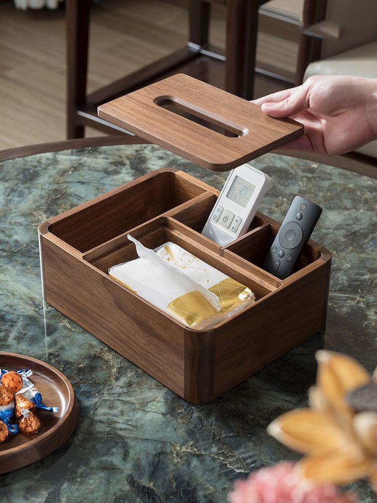 Enhance your home decor with the classic black walnut wooden organizer, a multifunctional piece that combines elegance and practicality. Crafted from premium black walnut wood, this organizer serves as a stylish tissue box and remote control holder, ensuring your essentials are always within reach. The rich, dark wood finish adds a touch of sophistication to any room, while the sturdy construction guarantees long-lasting use. Perfect for living rooms, bedrooms, or offices, this versatile organizer helps you maintain a tidy and organized space. Keep your tissues and remotes neatly stored and easily accessible with this beautifully designed black walnut wooden organizer. Material:Black WanlutSize:27.5cm(L)*21.5cm(W)*9.5cm(H) (1 inch=2.54cm) Living Room Organizer Ideas, Ice Cream Sticks, Remote Control Holder, Wooden Organizer, Remote Holder, Ice Cream Stick, Furniture Design Wooden, Small Woodworking Projects, Woodworking Inspiration