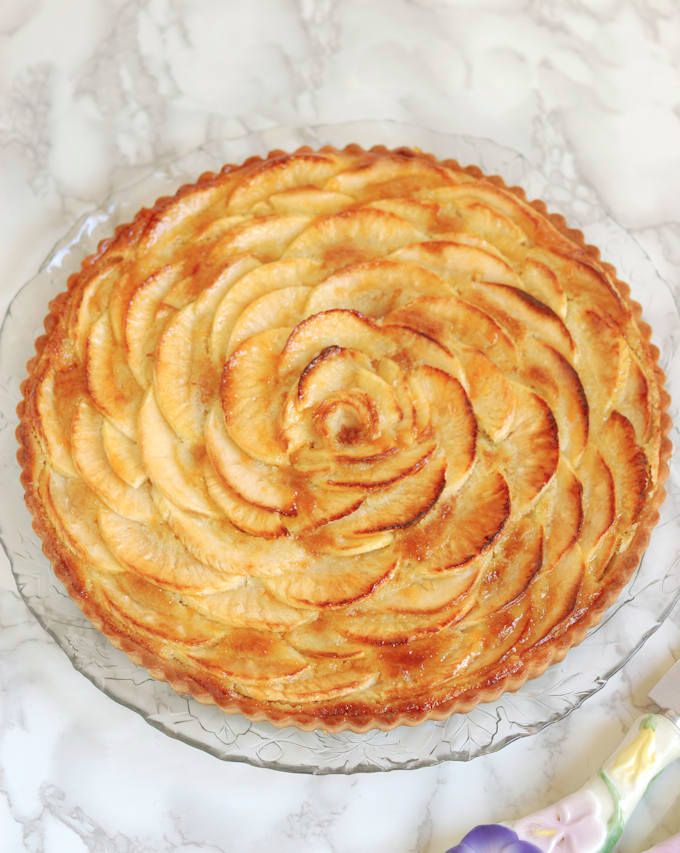 an apple pie is shown on a glass plate