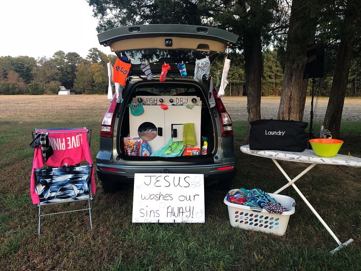 the back of a car with its trunk open and it's clothes on display