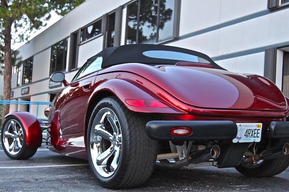 a red sports car parked in front of a building