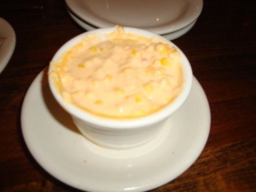 there is a bowl of soup on the plate next to another bowl with something in it