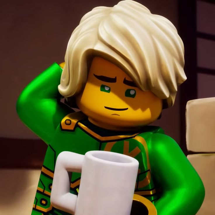 a lego man holding a white coffee mug in his right hand and wearing a green outfit