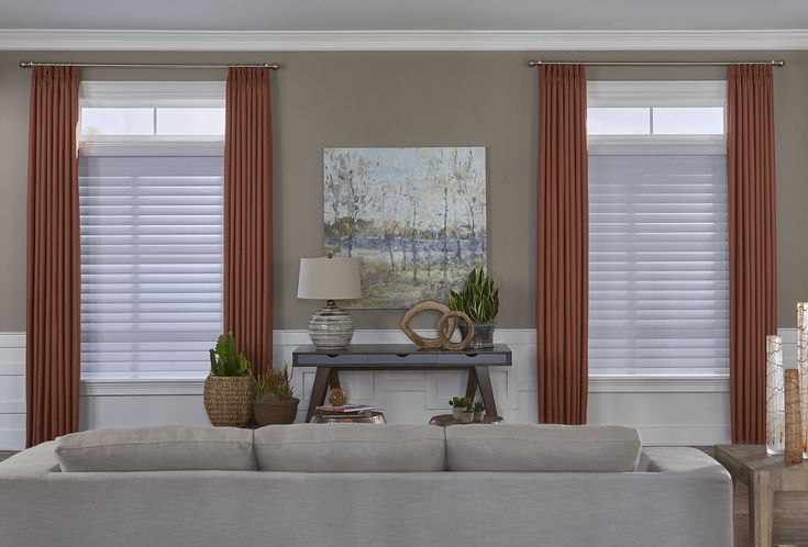 the living room is clean and ready to be used for decorating with orange drapes