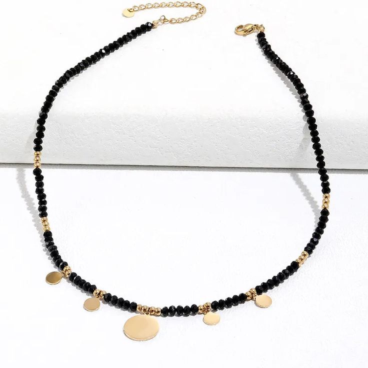 This one-of-a-kind Tori Black Beaded Necklace is sure to catch eyes with its bold mix of edgy black and glitzy gold. A shimmering statement piece for daring fashionistas, it'll add a modern touch to any look! #stylegameonpoint Size: 16 inches with 2 inch extender Materials: Stainless Steel 18K Gold Plated Trendy Round Beads Necklaces For Party, Trendy Round Bead Necklaces For Party, Trendy Round Beads Necklace For Party, Trendy Metal Jewelry With Black Beads, Metal Beaded Necklaces With Round Beads For Party, Trendy Black Beaded Necklaces For Party, Trendy Black Beaded Necklace For Party, Trendy Black Beads Necklace For Party, Party Necklace With Gold Beads