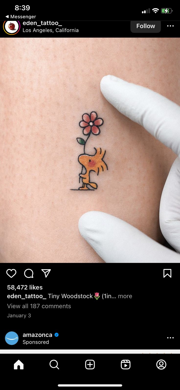 someone is showing off their small tattoo on the side of their stomach that has a dog holding a flower in it