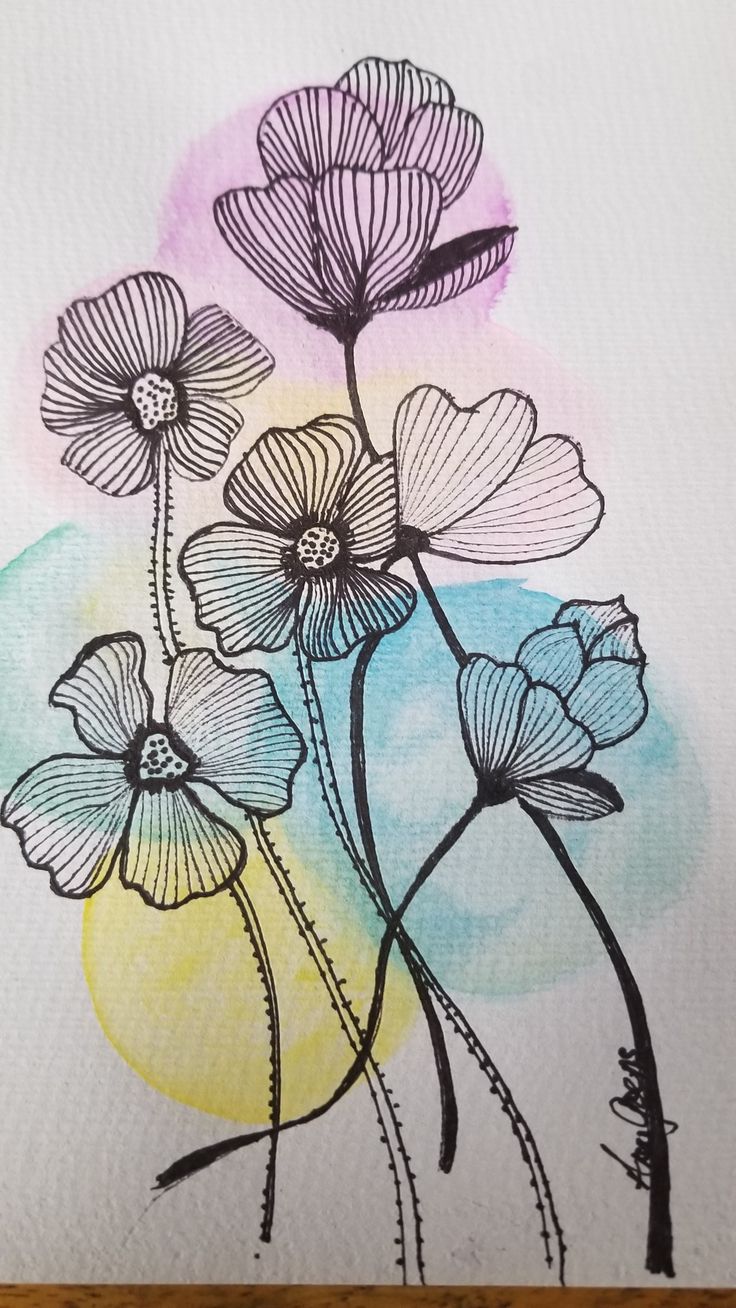 an ink drawing of flowers on paper with watercolor and pencils in the background