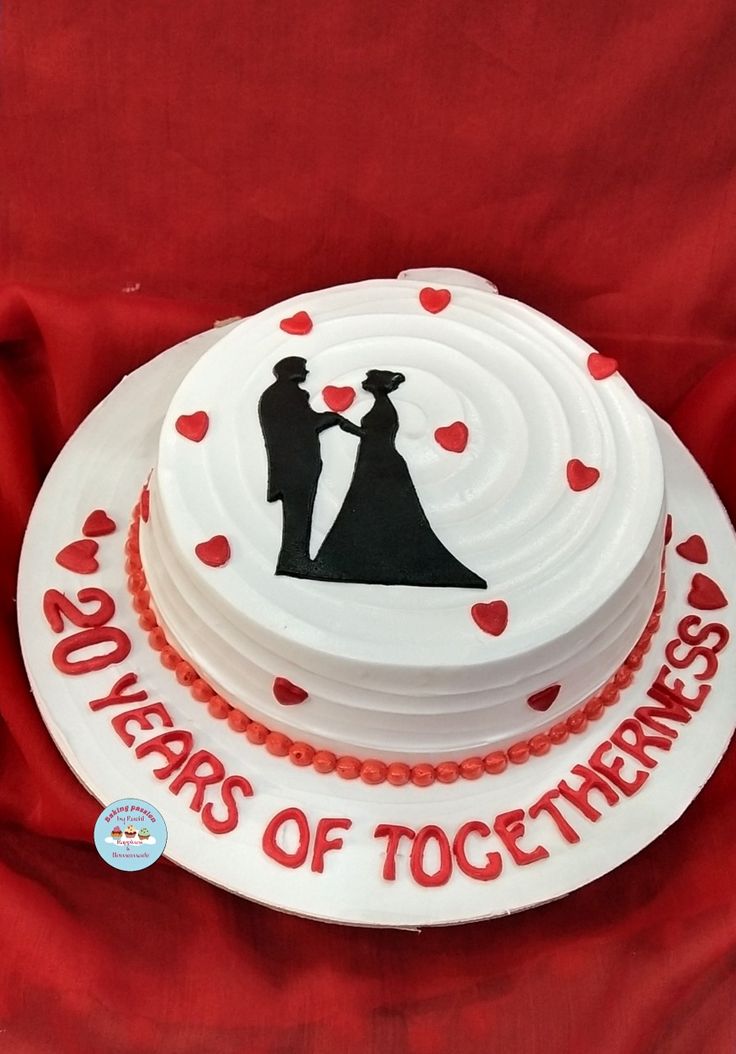 a white cake with red icing and hearts on it that says 50 years of together