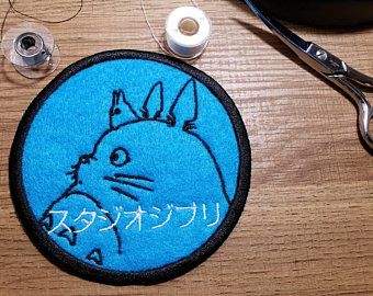 a pair of scissors sitting on top of a wooden table next to a blue rug