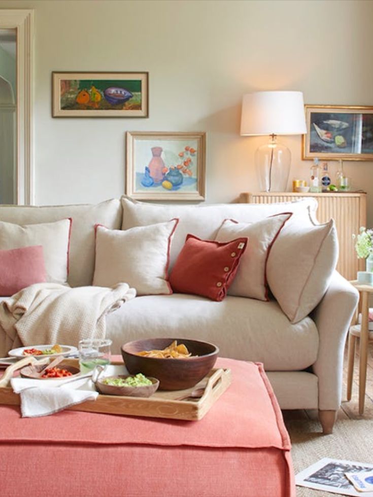 a living room filled with furniture and a bowl of food on top of a coffee table