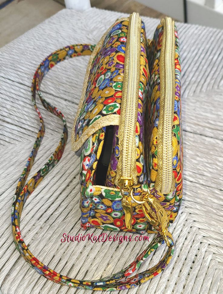 a multicolored purse sitting on top of a table