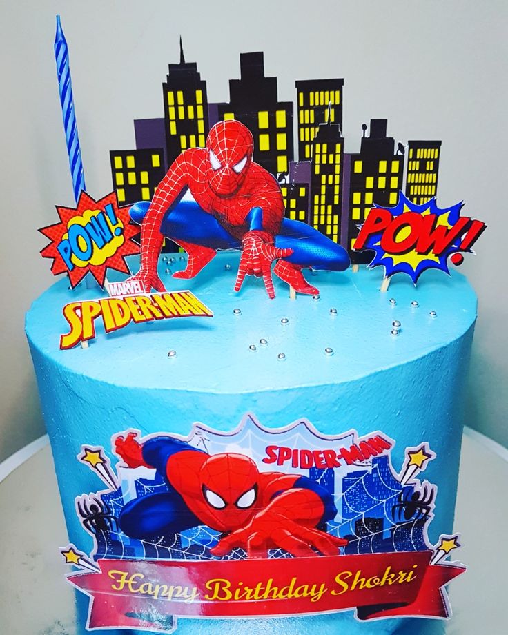 a birthday cake with a spiderman theme on it