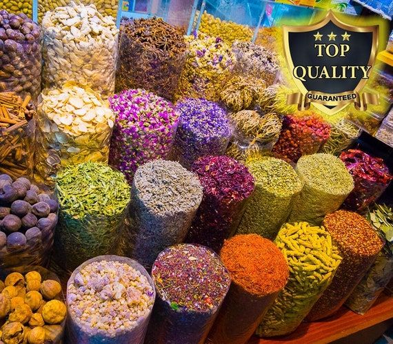 many different types of flowers and nuts on display at a market stall with the top quality badge