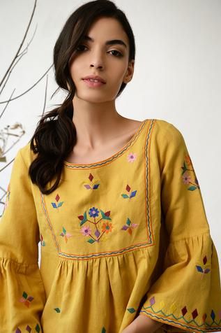 Mustard yellow dress with Kutch inspired floral thread work.
Components: 1
Fabric: Cotton linen
Neckline: Wide
Sleeve Length: Three quarters
Color: Yellow
Embroidery
Bell sleeves
Gathered silhouette
Closure: Back buttons - Aza Fashions Mustard Yellow Dresses, Thread Work, Dresses Short, Wide Sleeves, Designer Wear, Dress For Women, Women Dresses, Embroidered Dress, Yellow Dress