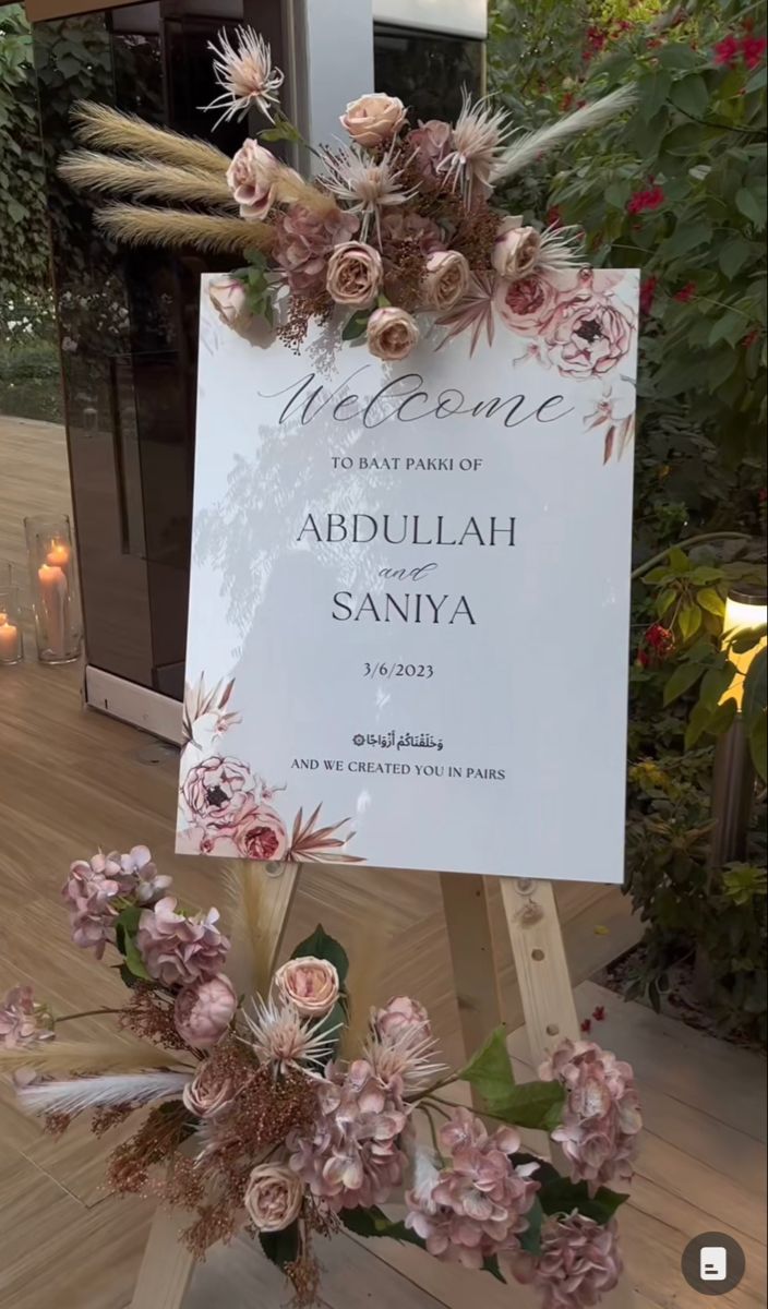 a welcome sign with flowers on it