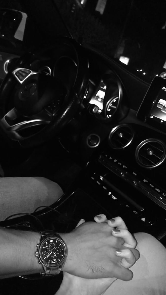 black and white photograph of a woman's wrist on the steering wheel of a car