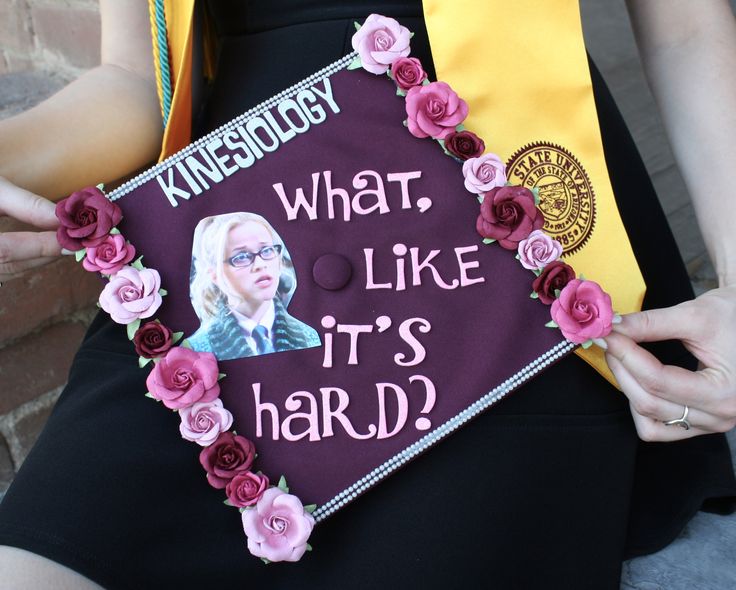 a woman wearing a purple graduation cap with pink flowers on it and the words what, like it's hard?