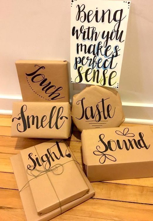 four wrapped presents sitting on top of a wooden floor next to a sign that says smile sound