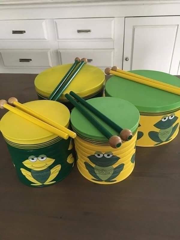 some green and yellow containers with pencils in them