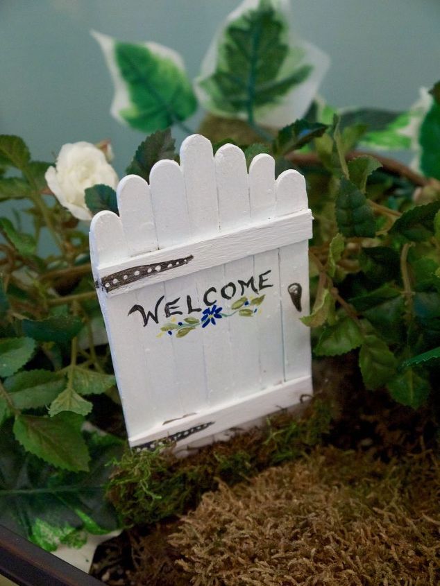 a welcome sign sitting on top of a potted plant