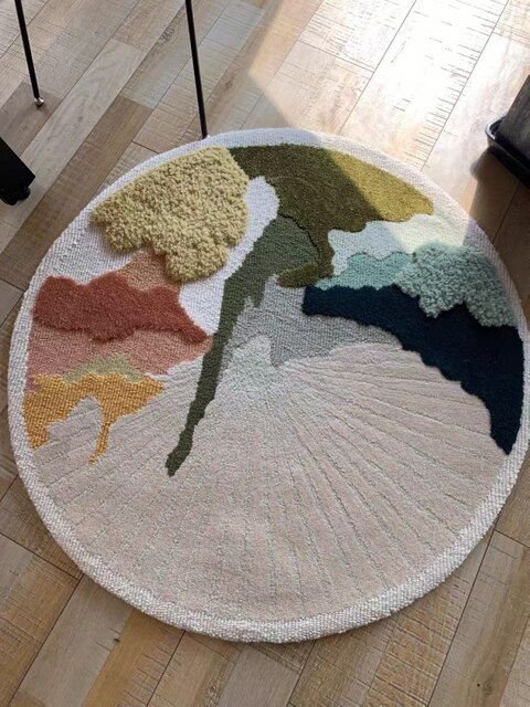 a round rug with different colors and shapes on the floor