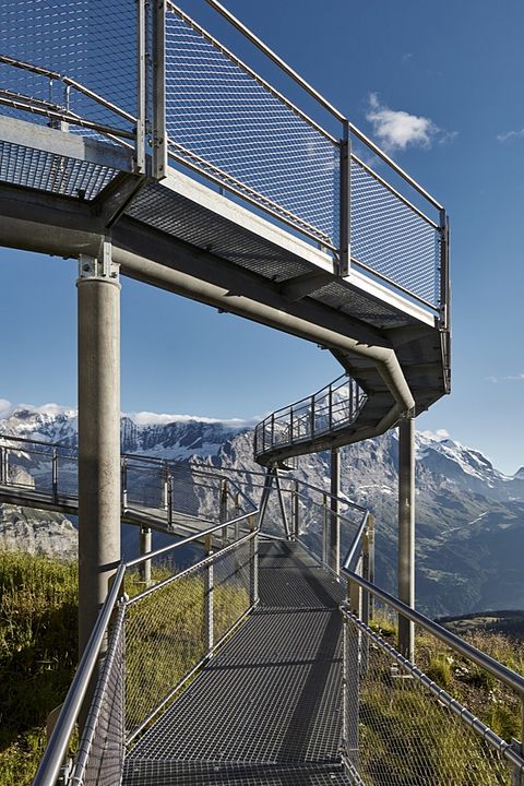 a metal walkway leading to the top of a mountain