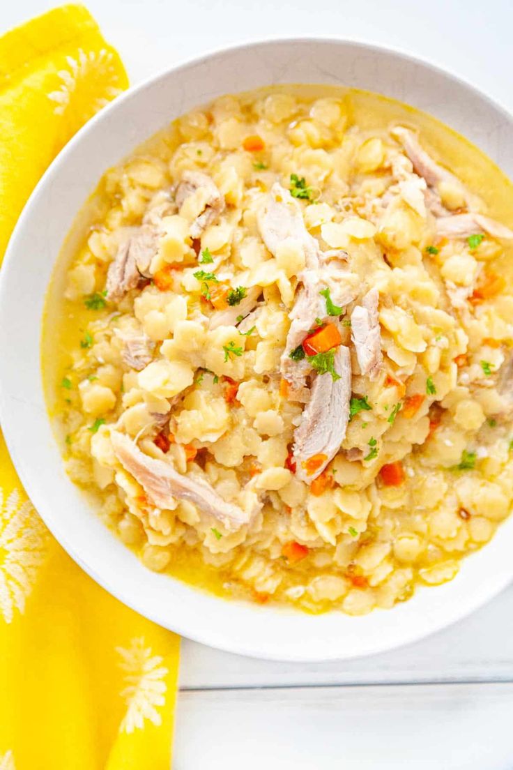 a white bowl filled with macaroni and cheese on top of a yellow napkin