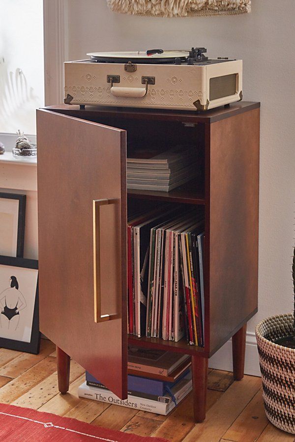 a record player sitting on top of a wooden cabinet