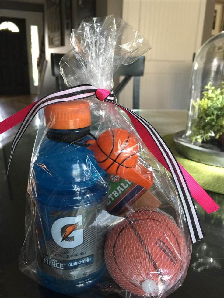 a bag filled with sports items on top of a table next to a basketball and water bottle