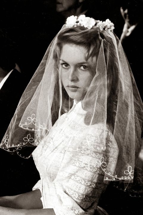 black and white photograph of a woman wearing a wedding veil