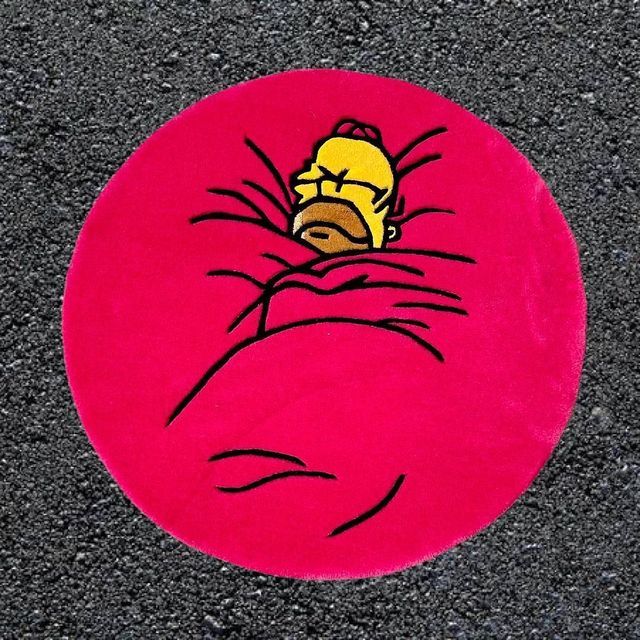 a red round with a cartoon character on it's face in the middle of pavement